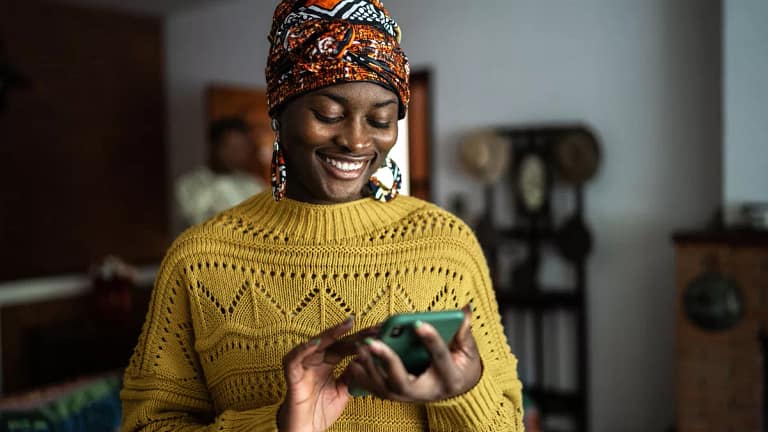 smiling person looking at smartphone.jpg