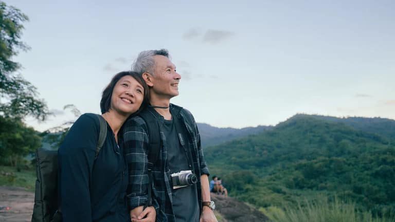 smiling senior couple out hiking.jpg
