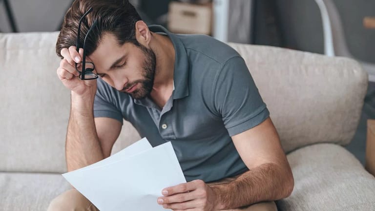 Upset man with bills HHrNeEJ.width cmCp.jpg