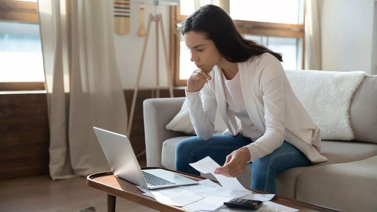 Woman looking at her computer while working o.width TmoSZ.jpg