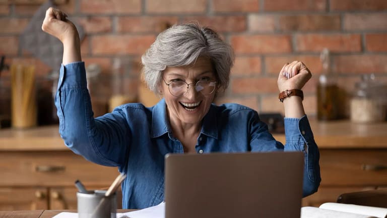 excited retiree looking at computer.jpg