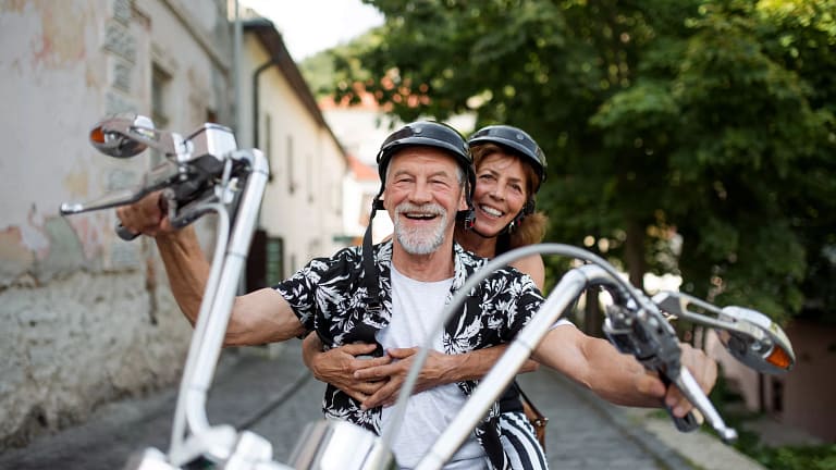 getty smiling happy couple on motorcycle.jpg