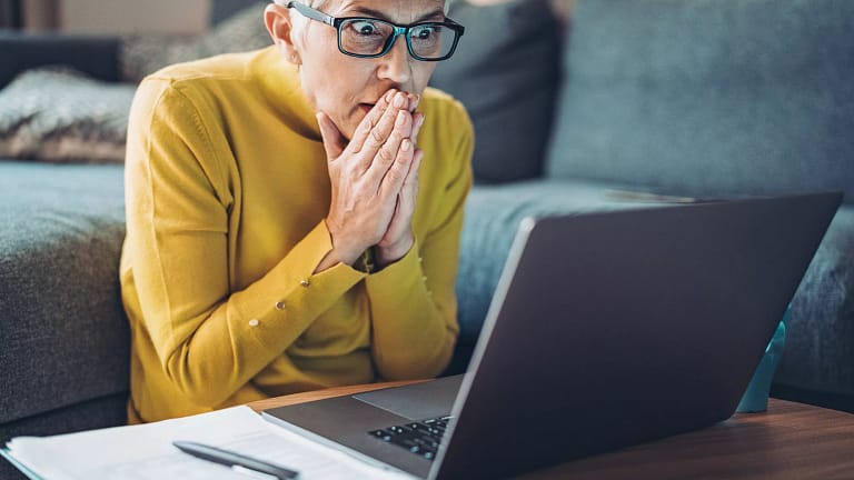 mature woman looking at computer in shock.jpg