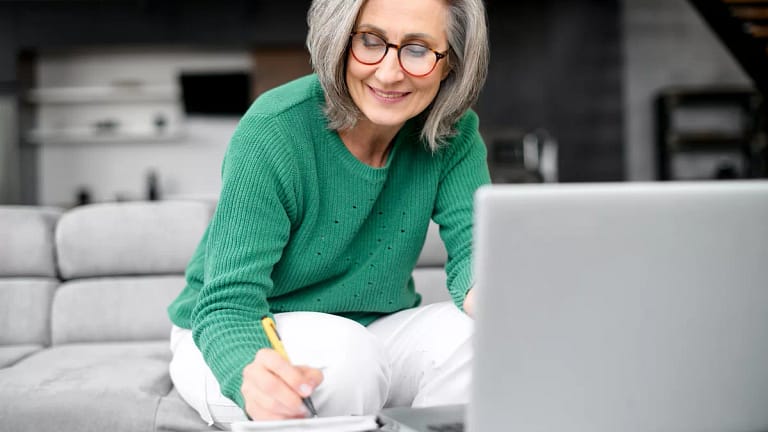 older adult in living room reviewing finances.jpg
