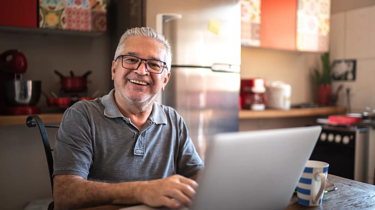 older man laptop smiling gettyimages .jpg