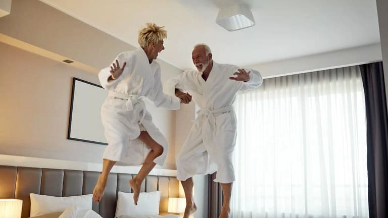older couple jumping on beds pmgaTwT.width .jpg