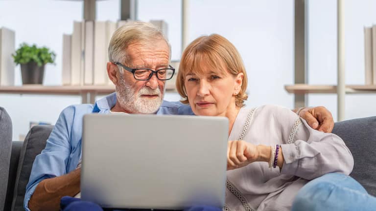perplexed senior couple looking at laptop.jpg