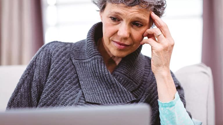person with a worried expression looking at a laptop copy.jpg