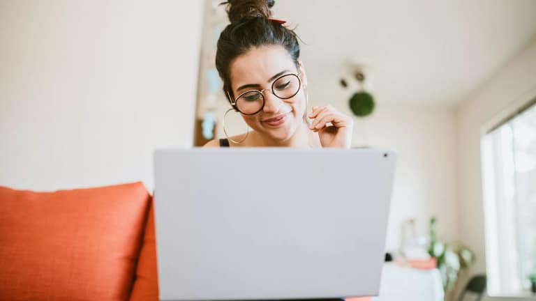 smiling person looking at laptop.jpg
