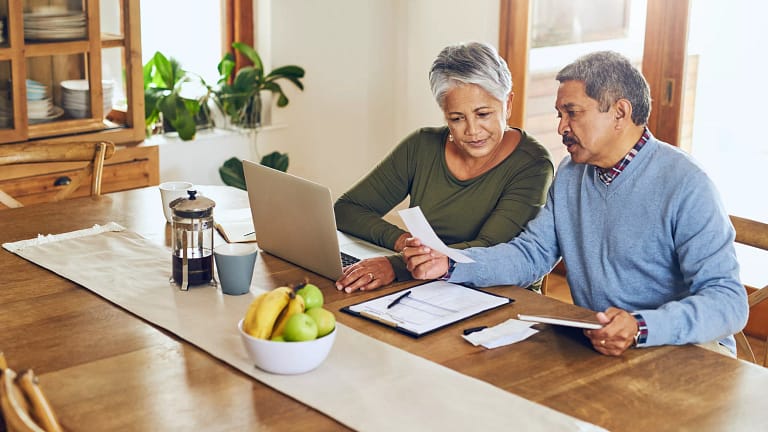 two people sitting at a table looking at paperwork.jpg