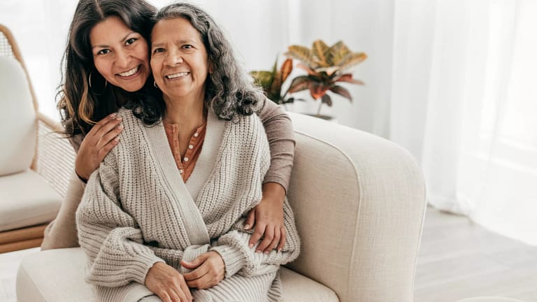 two people sitting on a couch and smiling.jpg